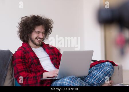 man freelancer in bathrobe working from home Stock Photo