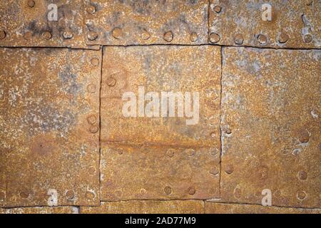 Rusty metal plates with rivets as background Stock Photo