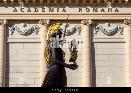 Bucharest, Romania - November 05, 2019: The statue of the goddess Minerva, made by sculptor Mihai Ecobici, is seen in front of The Romanian Academy, i Stock Photo