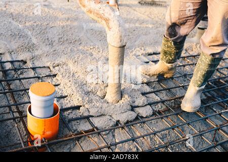 Concrete pouring during commercial concreting floors of buildings in construction Stock Photo