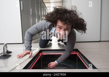 engineer connecting cables in server room Stock Photo
