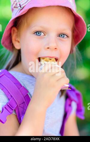 girl eating chocolate wafers - chocolate bar Stock Photo