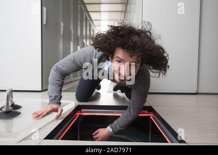 engineer connecting cables in server room Stock Photo