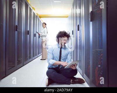 Team Of Young Technicians Working Together On Servers Stock Photo - Alamy