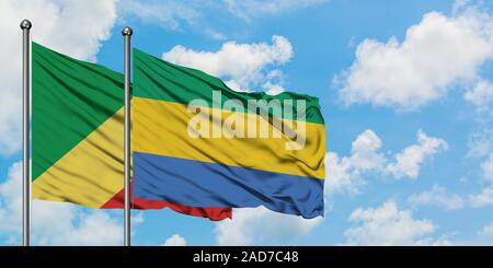 Republic Of The Congo and Gabon flag waving in the wind against white cloudy blue sky together. Diplomacy concept, international relations. Stock Photo