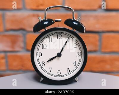 Retro alarm clock on table Stock Photo