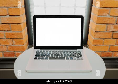 Laptop with blank screen on table Stock Photo