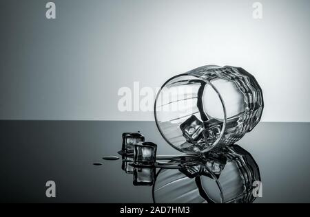 Lying glass with ice cubes Stock Photo