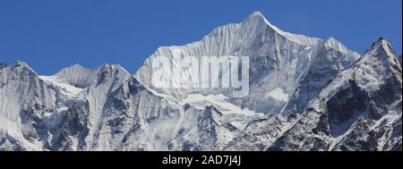 Mount Gangchenpo on a clear spring day after snowfall. High mountain in the Langtang valley, Nepal. Stock Photo