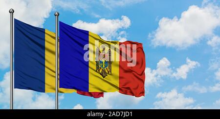 Romania and Moldova flag waving in the wind against white cloudy blue sky together. Diplomacy concept, international relations. Stock Photo