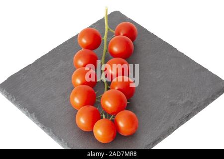 Fresh cherry tomatoes on black slate plate Stock Photo