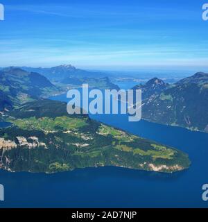 View from Mount Fronalpstock. Lake Lucerne in summer. Green meadows and mountains. Village Seelisber Stock Photo