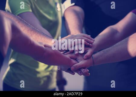 runners giving high five to each other Stock Photo