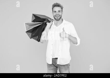 Best price. Cyber monday. Total sale. Positive man enjoying shopping. Happy man with shopping bags. Excited smiling guy doing shopping. Shopping happiness. Nice purchase. Gifts for holidays.