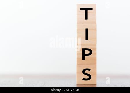 Tips written on wooden cubes with copy space Stock Photo
