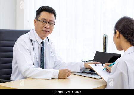 Two doctors in the hospital discuss the diagnos of the patient Stock Photo