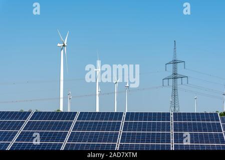 Electricity pylons, solar panels and wind turbines seen in Germany Stock Photo