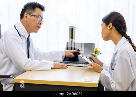 Two doctors in the hospital discuss the diagnos of the patient Stock Photo