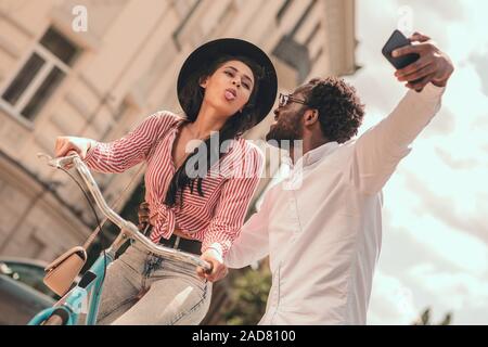 Lady on the bike taking selfie with boyfriend stock photo Stock Photo