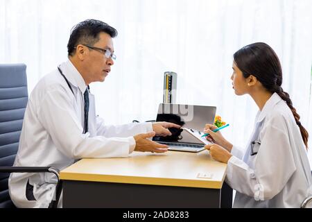 Two doctors in the hospital discuss the diagnos of the patient Stock Photo