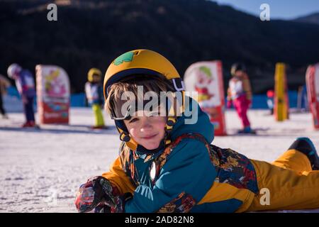 little snowboarder lying on the snow Stock Photo