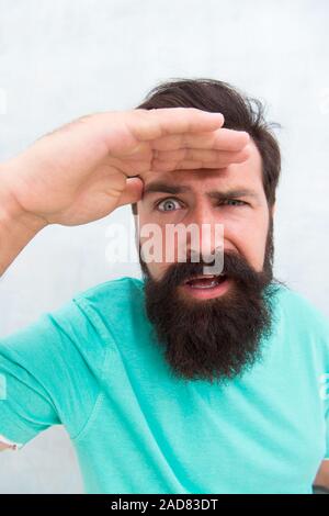 Suspicious look. Man bearded hipster stylish beard grey background. Perceptions of male beauty. Stylish beard and mustache care. Strict face. Beard fashion barber. Handsome guy. Masculinity concept. Stock Photo