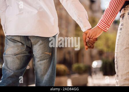 Two people holding hands outdoors stock photo Stock Photo