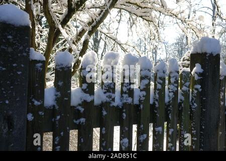 Wooden fence in the snow on winter country background Stock Photo - Alamy