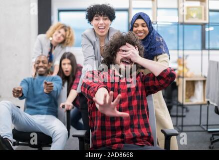 multiethnics Business team racing on office chairs Stock Photo