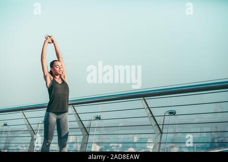 Peaceful sportswoman doing upper body stretches stock photo Stock Photo