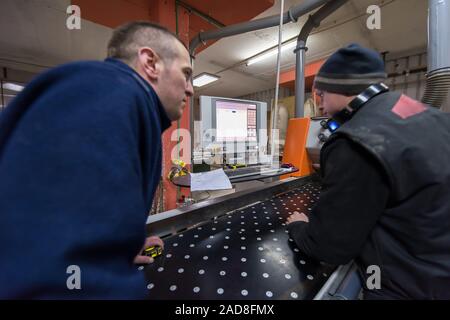 carpenters calculating and programming a cnc wood working machine Stock Photo