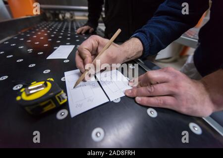carpenters calculating and programming a cnc wood working machine Stock Photo