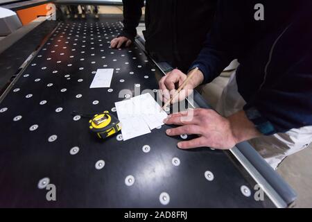 carpenters calculating and programming a cnc wood working machine Stock Photo