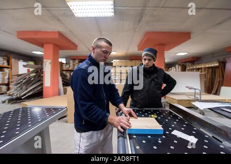 carpenters calculating and programming a cnc wood working machine Stock Photo