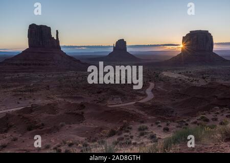 The sun rises behind the Merrick Butte in Monument Valley, Arizona, US Stock Photo