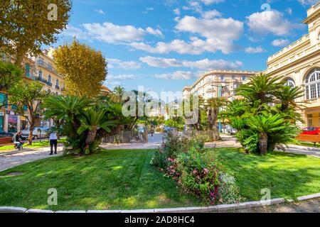 The Alpes Maritimes mountains rise behind the Jardins Bioves in the city center of the seaside village of Menton, France, on the French Riviera. Stock Photo