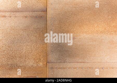 Rusty iron plate with rivets as background Stock Photo
