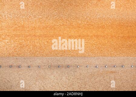Rusty iron plate with rivets as background Stock Photo