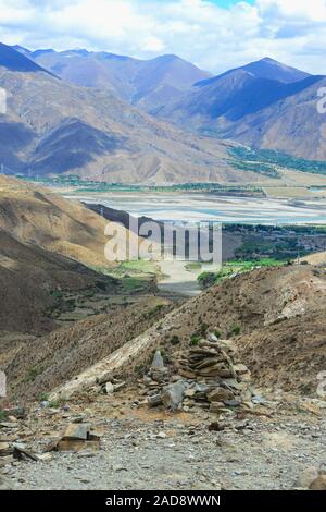 A cairn sits atop a mountain overlooking Brahmaputra Valley of Tibet Autonomous Region in China. Stock Photo