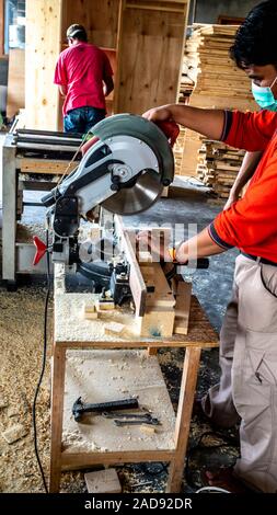 A carpenter cut the wood using machine in his workshop. the process of making furniture Stock Photo Alamy