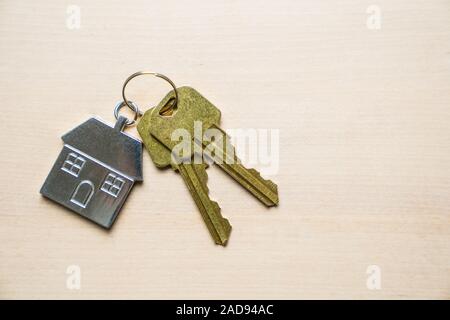 House keys and keychain on wooden background Stock Photo