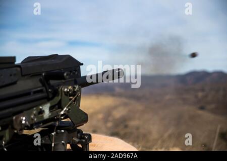 A U.S. Marine with Delta Company, Infantry Training Battalion, School of Infantry West, fires a MK19 40 mm automatic grenade launcher during a live-fire range on Range 204B on Marine Corps Base Camp Pendleton, California, Dec. 2, 2019. This range is part of their culminating event and is a graduation requirement. Delta Company is scheduled to graduate Dec. 6, 2019. (U.S. Marine Corps photo by Lance Cpl. Alison Dostie) Stock Photo