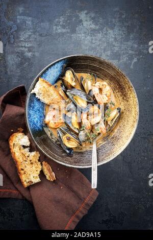 Traditional French Corsican seafood stew with prawns and mussels as top view in a modern design Japanese bowl Stock Photo