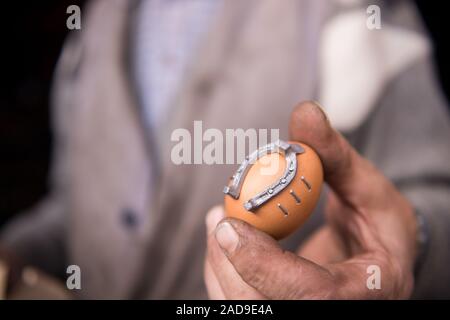 A blacksmith worker showing handmade products ready for sale Stock Photo