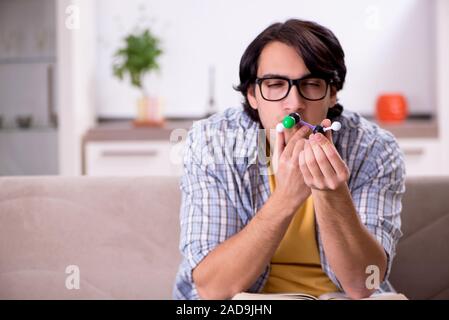 Young student physicist preparing for exam at home Stock Photo