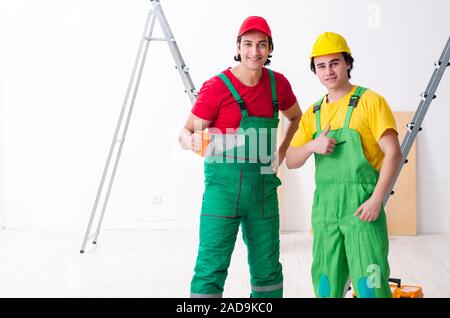 Two workers contractors working indoors Stock Photo