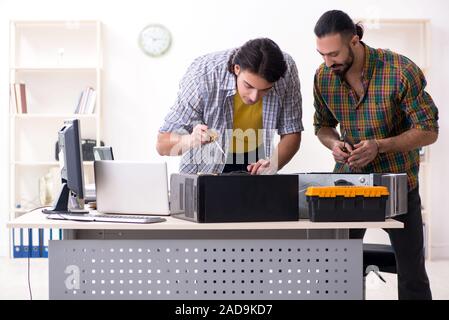 IT engineers working on hardware issue Stock Photo