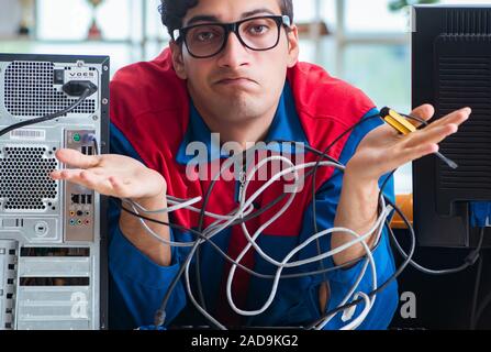 Computer repairman working on repairing computer in IT workshop Stock Photo