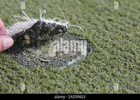 Damaged artificial turf Stock Photo