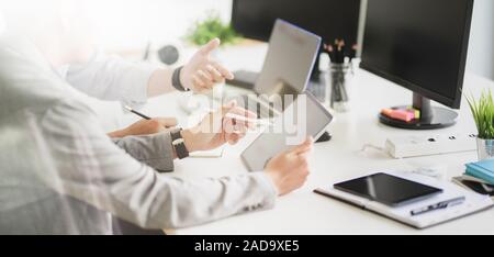 Cropped shot of young professional UX web developer working on smartphone template together Stock Photo